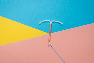 An IUD device on a colorful background