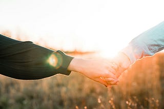 holding hands outdoors