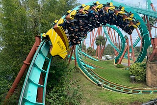 People riding a roller coaster upside down.