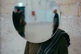 curved surveillance mirror blocking a person’s face