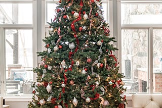Did your Christmas tree every look as perfectly symmetrical and decorated as this one with red and white bulbs and ribbons? Mine either.