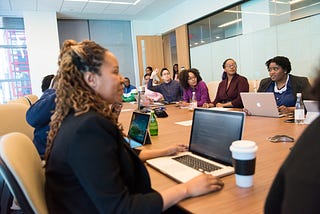 Adult professionals sitting around a conference table