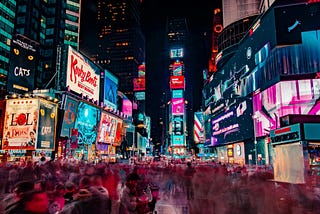 A bunch of lit-up neon signs in Times Square New York.