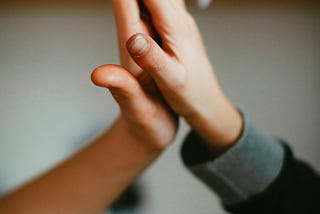 Two young boys make a friendship hand clap