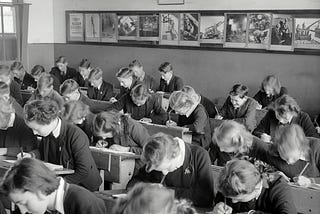 Interior of a classroom, students bent at study, Yallourn, 1947.