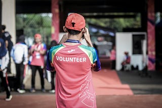 Volunteer taking photo of crowd