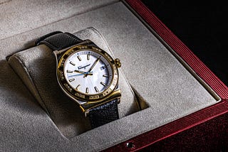 A gold watch in a display box