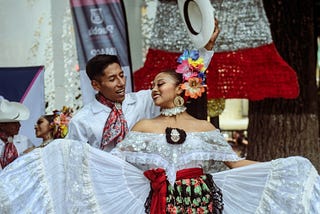 Dancers publicly showcasing the culture in Costa Rica through their clothing and movements.