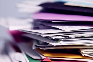 Files and documents piled one over the other with no organisational structure.