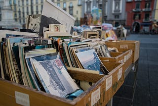 A collection of records in wooden boxes for sale.