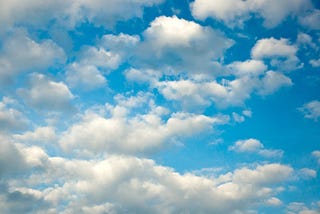 Fluffy white clouds on a blue sky.