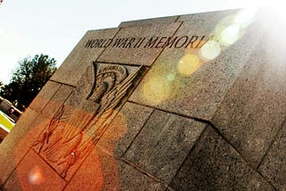 photo of world war 2 memorial with engraving of eagle and tree in background; posted on mickey markoff 2024 article on navajo code talkers day