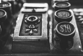 Antique cash register buttons in black and white.