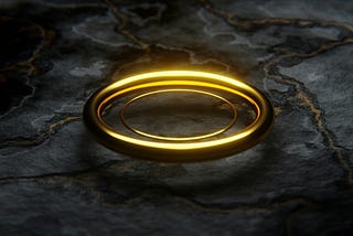 a gold ring on black marble