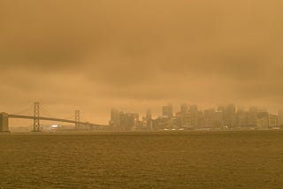 Smoke from California wildfires cast an orange hue over San Francisco and the Bay Bridge