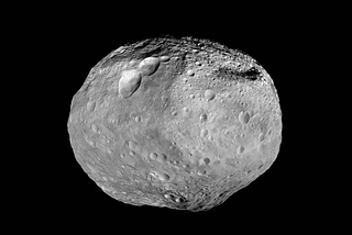 Black and white image of asteroid Vesta in space.