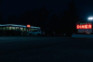 A small barely lit diner at night