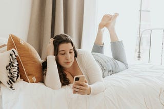 A woman relaxing while on her phone