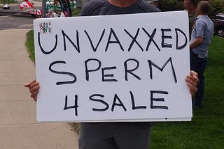 “Unvaxxed Sperm 4 Sale” reads a protest sign.