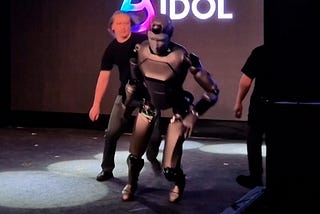 a humanoid about to fall with a guy on the back ready to pick it. It comes from the russian mega flop