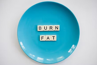 A blue colored plate with letter blocks in it.