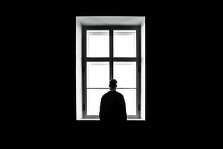 A man staring out a window