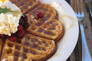 waffle on a plate with fruit