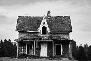 an old abandoned house in a desolate setting