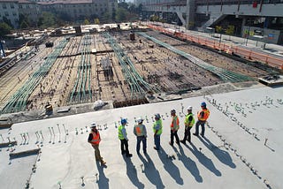 Engineer standing against a fractured city system, symbolizing quiet resilience.