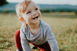 A small kid is planning to learn how to get up. This is an emblemetic of starting something new that is more resilient.