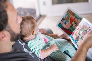 A father reading to a young child