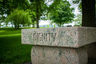 The word “dignity” inscribed on a stone.