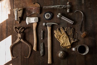 Various tools displayed on a wooden table.