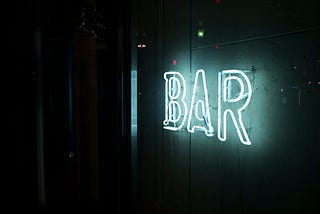 A neon sign saying ‘bar”.