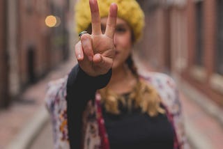 woman with peace sign close up