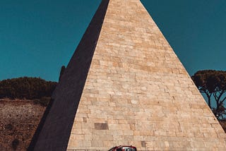 The Pyramid of Cestius, my favorite Roman landmark, right in the middle of the road.