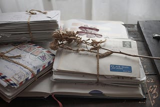 Pile of letters binded on a wooden desk