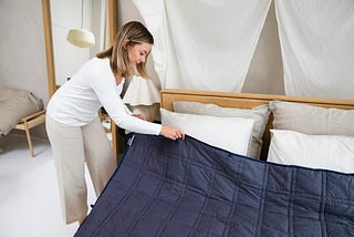 Woman making her bed.