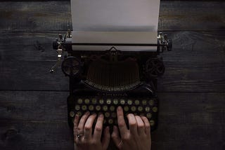 writer using an old-fashioned typewriter