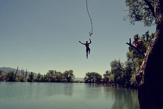 A person jumping into water from a high height.