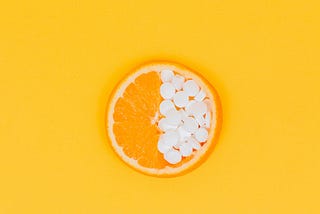 Orange slice with pills as one half