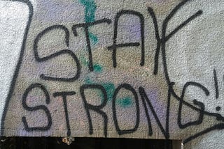 Writing on wall that says, “Stay Strong.”