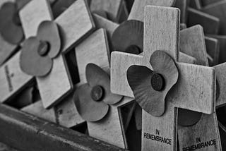black-and-white photo of memorial crosses that say IN REMEMBRANCE
