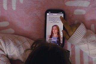 A person scrolling on a mobile phone.