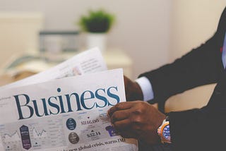 A person reading a business magazine