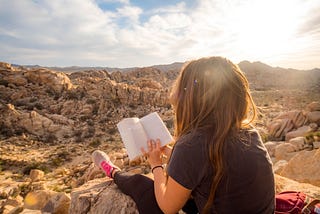 Image of woman reading in the mountains for 5 Books that Changed my Life 180°