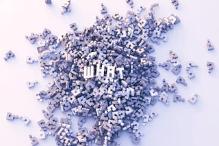 Masses of light grey 3D question marks in an unordered pile on a white background, on top of the pile the letters W, H, A and T in white to illustrate the word “What”