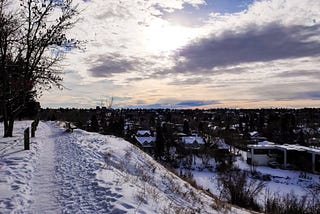 Snowy hilltop views of faraway mountains