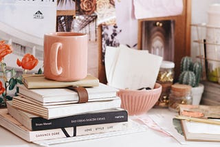 A desk filled with books and writing supplies to inspire creativity