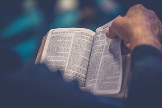 A person flips through a Bible.